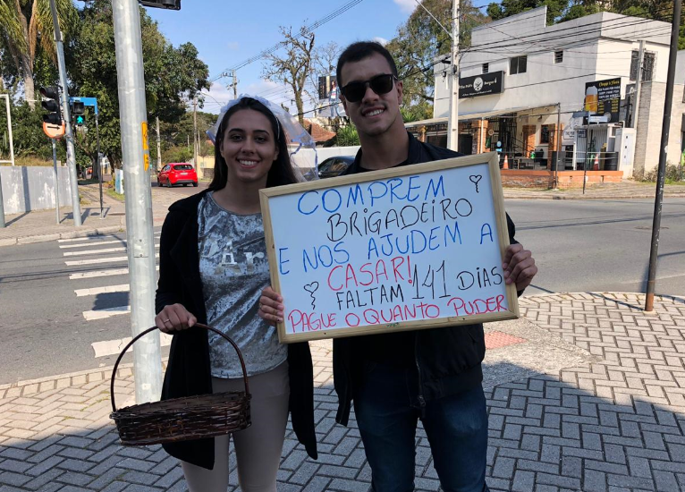 Casal de noivos vende brigadeiros em sinaleiro do Batel para juntar dinheiro para o casamento