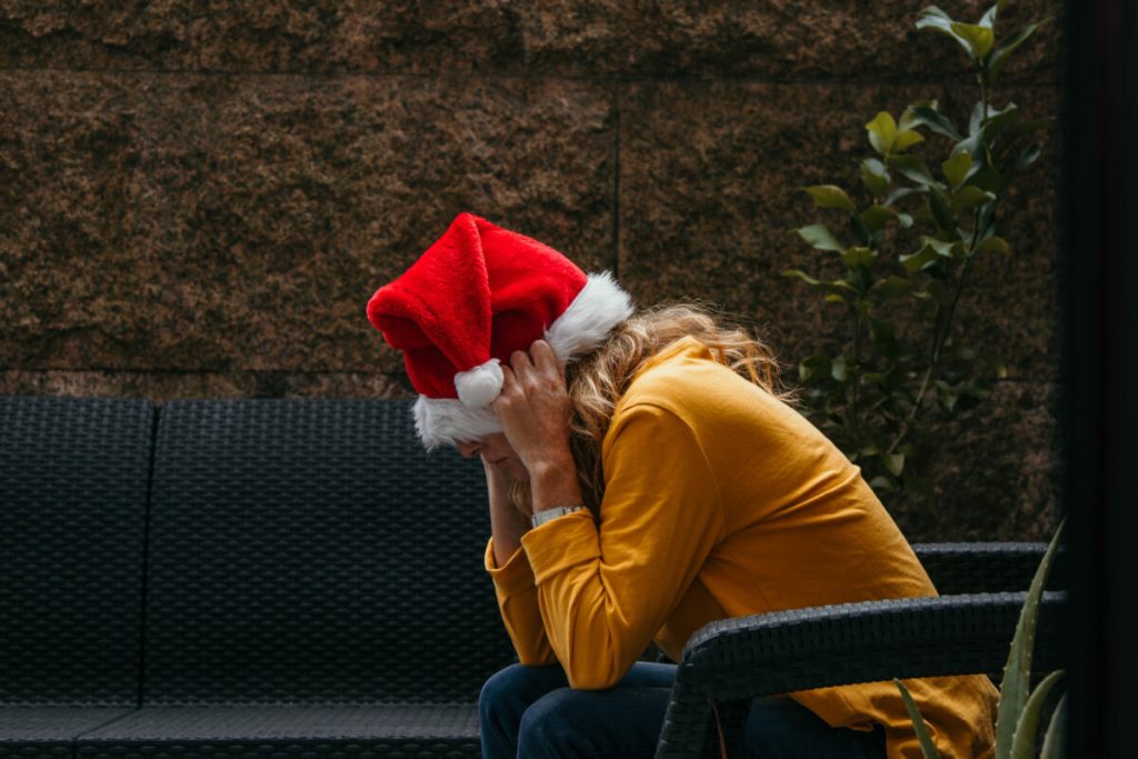 woman with santa claus hat stressed