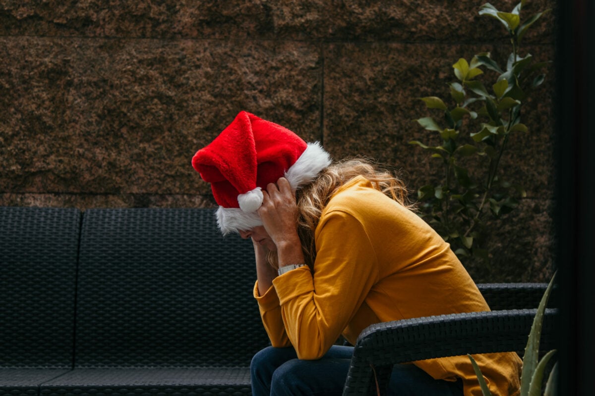 woman with santa claus hat stressed
